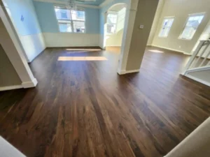 Dark walnut engineered hardwood flooring installed throughout an open-concept home interior.